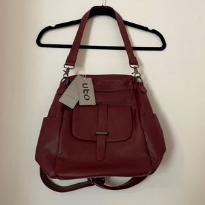 Burgundy synthetic leather backpack purse.